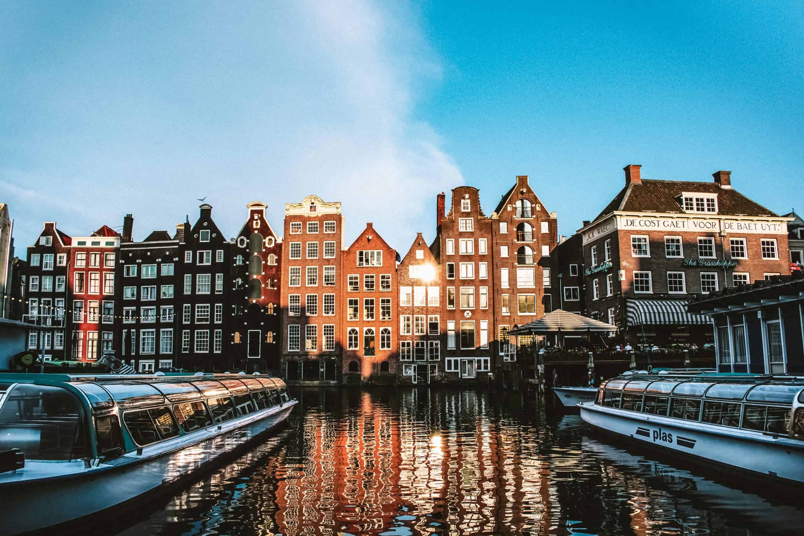 Canal houses and tour boats in Amsterdam